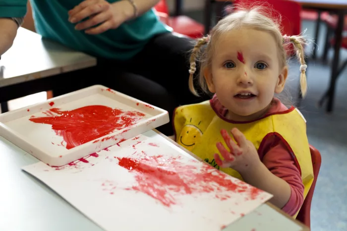 Young girl playing with paints