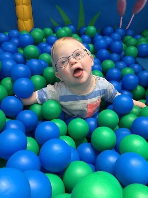 Reuben is playing in a ball pit. 