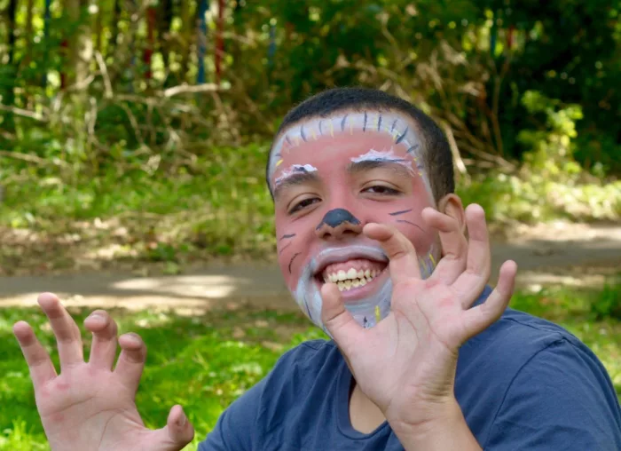 A young boy with face paint smiles