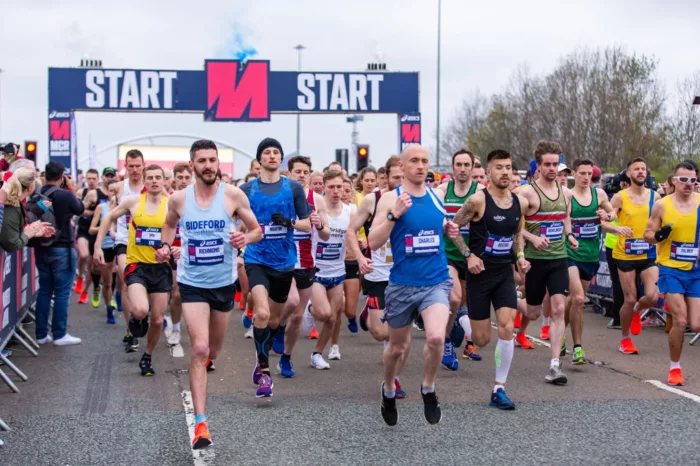 Runners are in the middle of the Manchester Marathon.