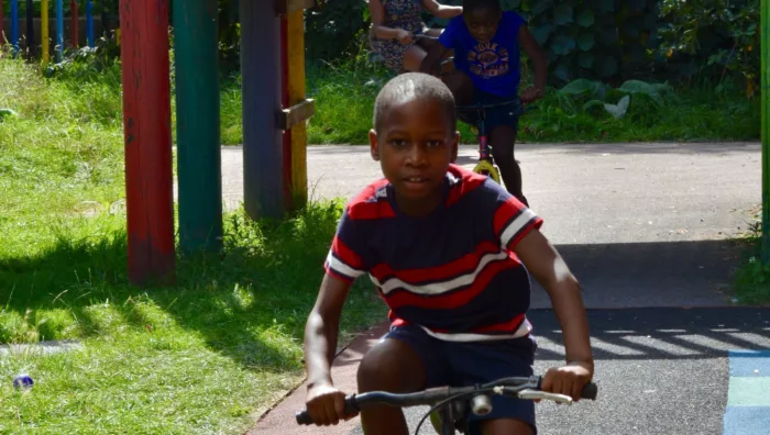 A young boy riding a bike