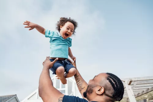 A man carrying a child in the air