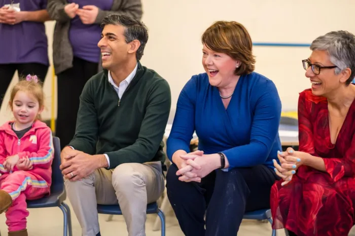 Prime Minister Rishi Sunak, Maria Miller MP, and Katie Ghose, Chief Executive of Kids sit with children at Kids' Basingstoke Nursery