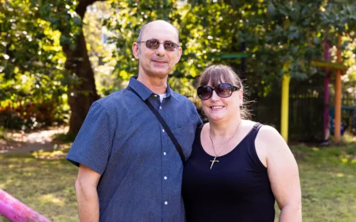 Two adults are standing together
