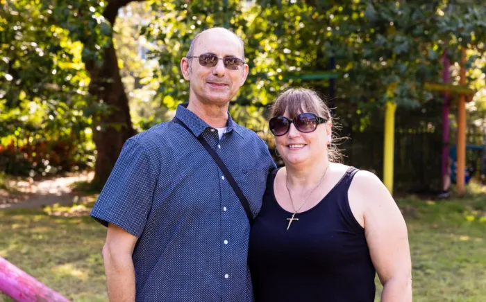 Two adults are standing together