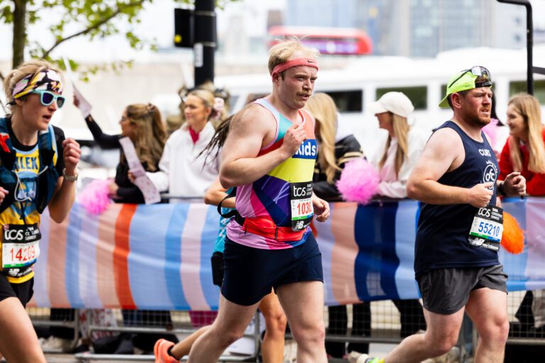 A man is running in a Kids vest