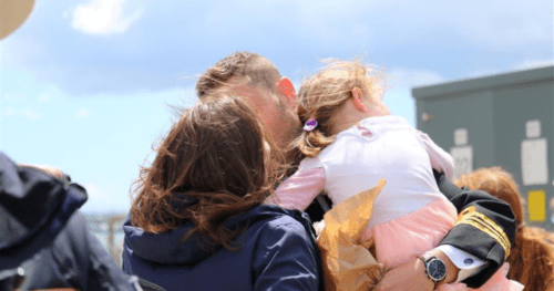 mum, dad and child hugging
