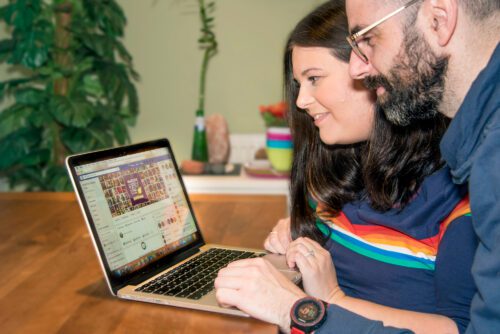 young woman and man looking at a laptop together