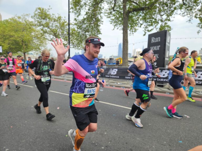 man waving running the london marathon