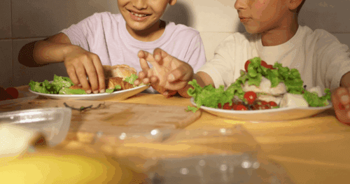 two children eating dinner