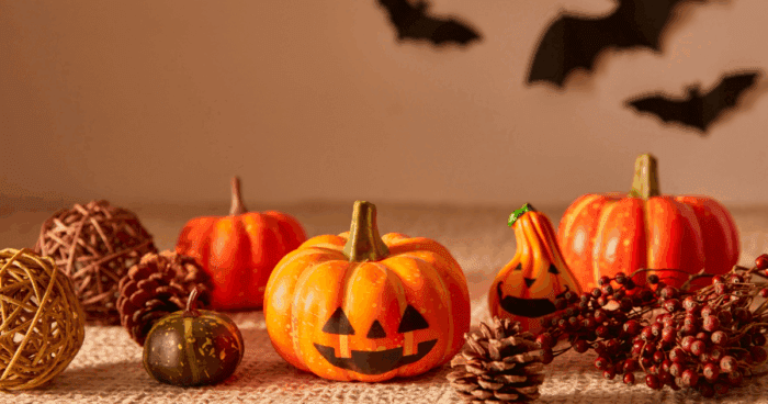 Halloween style orange pumpkins with faces drawn on the front of them