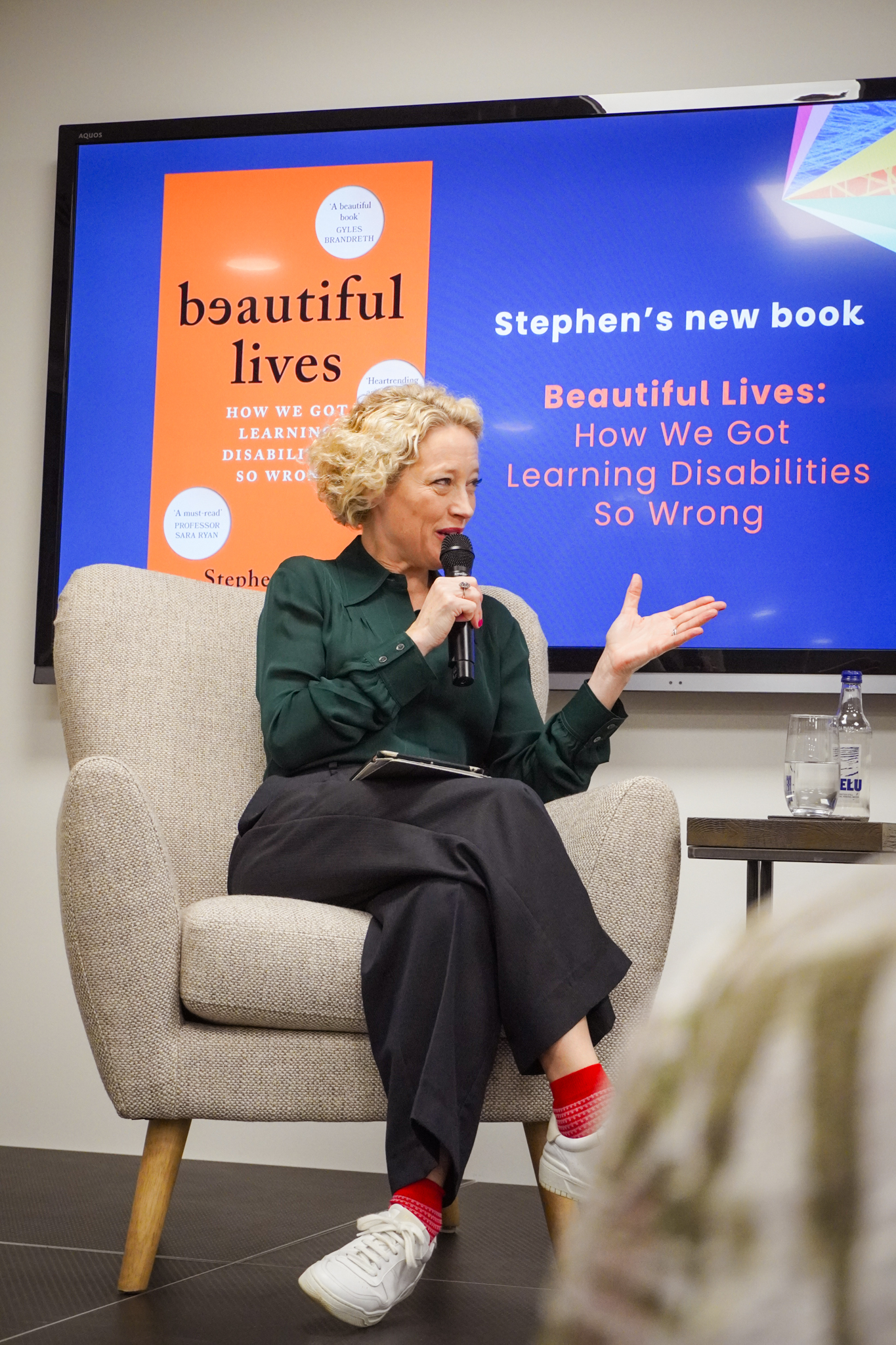 cathy newman sitting down and talking with a microphone