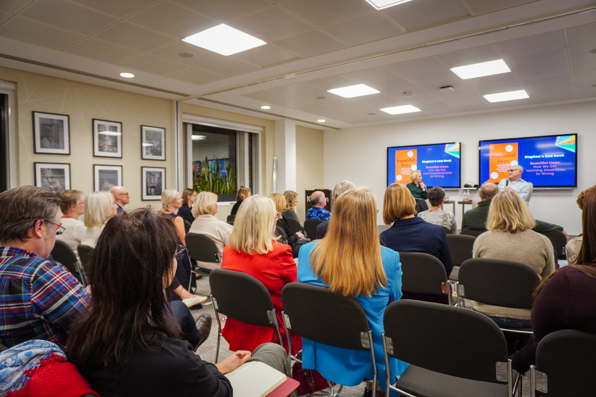 crowd of people sitting down watching cathy newman interview stephen unwin