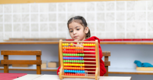 a young girl playing with an abacus
