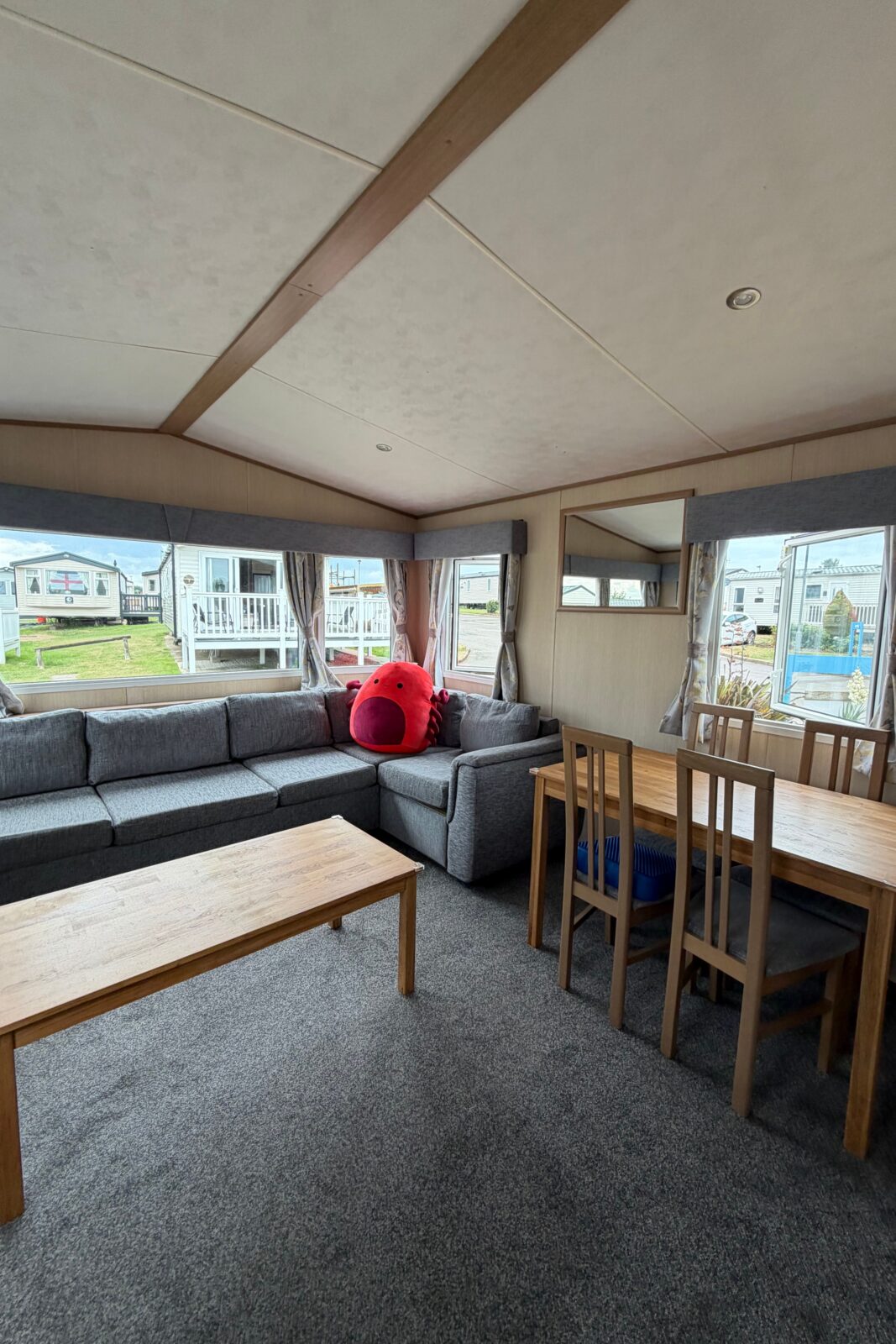living room with sofa and dining table and chairs in a caravan