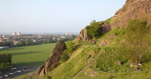 holyrood park from above with the city backdrop