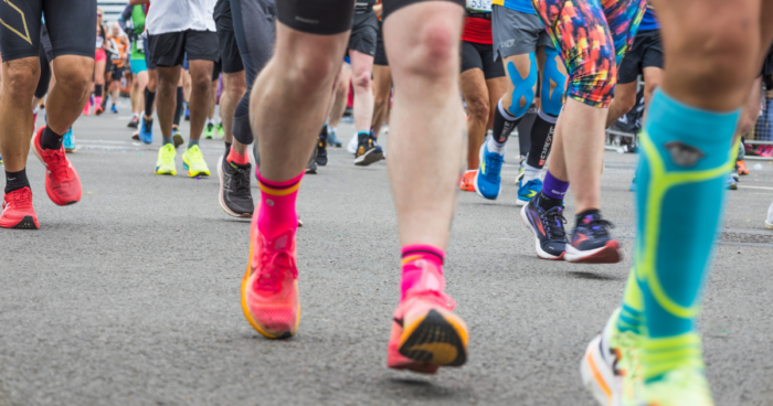 lots of runners' feet, in colourful trainers