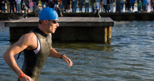 man begins his swimming triathlon race