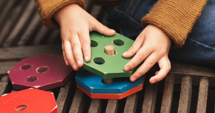 young boy plays with spatial toys